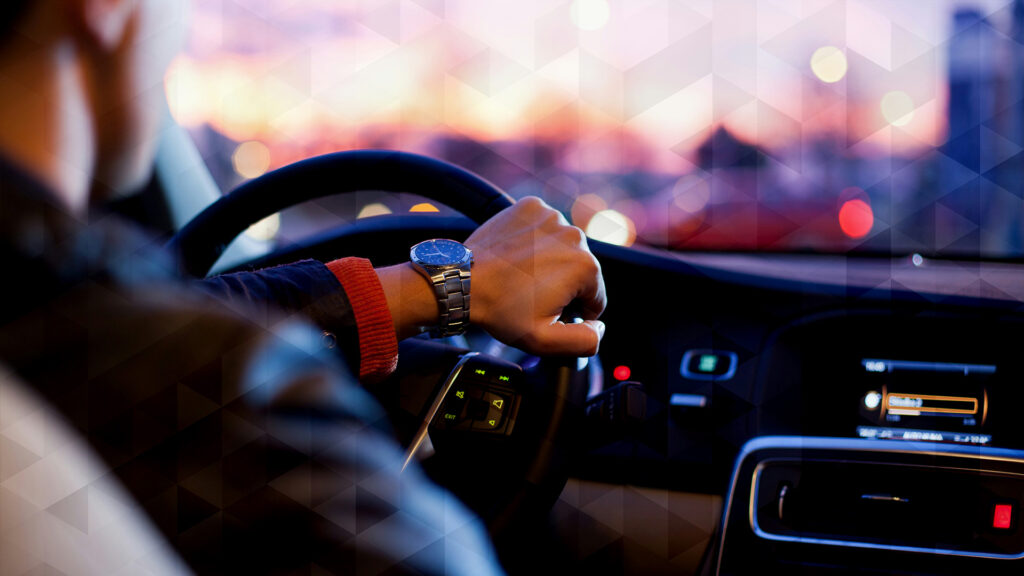 A man driving a luxury car
