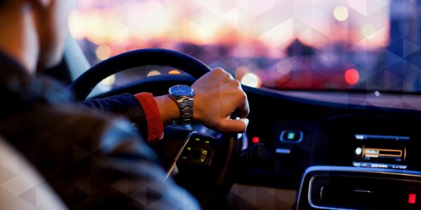 A man driving a luxury car